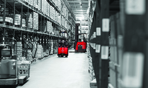 Raymond Courier Automated Pallet Truck in warehouse aisle